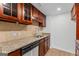 Kitchen area featuring wood cabinets, granite countertops and stainless steel dishwasher and sink at 1280 W Peachtreestreetsuffix=Street Nw # 808, Atlanta, GA 30309