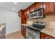 Kitchen area featuring granite countertops, stainless steel appliances, wood cabinets and tile backsplash at 1280 W Peachtreestreetsuffix=Street Nw # 808, Atlanta, GA 30309