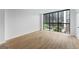 Living room with wood-look flooring, white walls, and a large window that offers clear cityscape views at 1280 W Peachtreestreetsuffix=Street Nw # 808, Atlanta, GA 30309