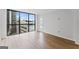 Living room with wood-look flooring, white walls, and a large window that offers clear cityscape views at 1280 W Peachtreestreetsuffix=Street Nw # 808, Atlanta, GA 30309