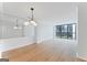 The spacious living room features modern lighting, updated flooring, and expansive windows with cityscape views at 1280 W Peachtreestreetsuffix=Street Nw # 808, Atlanta, GA 30309