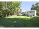 Expansive backyard showing well-maintained lawn, mature trees, and the back of the white home at 1349 Heather Cir, Riverdale, GA 30296