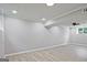 Open basement area features wood-look flooring and recessed ceiling lights at 1349 Heather Cir, Riverdale, GA 30296