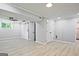 Spacious finished basement with wood-look floors, ceiling fan, and ample lighting at 1349 Heather Cir, Riverdale, GA 30296