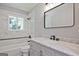 Renovated bathroom features a marble vanity and a stylish black framed mirror at 1349 Heather Cir, Riverdale, GA 30296