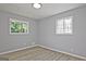 Bright bedroom features wood-look flooring and natural light from two windows at 1349 Heather Cir, Riverdale, GA 30296