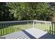 Wooden deck with painted railing overlooks the manicured yard at 1349 Heather Cir, Riverdale, GA 30296