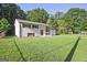 Spacious home showcasing a well-manicured lawn, white painted brick, dark shutters, and a charming red front door at 1349 Heather Cir, Riverdale, GA 30296