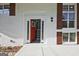 Inviting entryway with a vibrant red front door flanked by sidelights and white trim, plus dark exterior shutters at 1349 Heather Cir, Riverdale, GA 30296