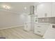 Bright kitchen features white cabinetry, stainless steel range hood, quartz countertops and modern finishes at 1349 Heather Cir, Riverdale, GA 30296