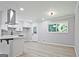 Bright kitchen features white cabinetry, stainless steel range hood, quartz countertops and modern finishes at 1349 Heather Cir, Riverdale, GA 30296