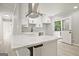 Bright kitchen features white cabinetry, stainless steel range hood, quartz countertops and modern finishes at 1349 Heather Cir, Riverdale, GA 30296