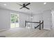 Bright living area featuring new wood flooring, neutral walls, modern ceiling fan, and updated railing at 1349 Heather Cir, Riverdale, GA 30296