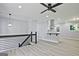 Open-concept living space with modern staircase, wood floors, fresh paint, and access to the updated kitchen at 1349 Heather Cir, Riverdale, GA 30296