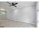 Spacious, freshly painted living room featuring wood flooring, a modern ceiling fan, and plenty of natural light at 1349 Heather Cir, Riverdale, GA 30296