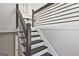 Staircase features modern metal railing, black stair treads, white risers, and freshly painted gray walls at 1349 Heather Cir, Riverdale, GA 30296