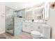 Modern bathroom features a walk-in shower, dual sink vanity with gold hardware, and updated fixtures at 1675 White Oak Way, Decatur, GA 30032