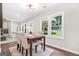Cozy dining area with a table for four, hardwood floors, and bright natural light at 1675 White Oak Way, Decatur, GA 30032