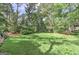 Large, well-maintained backyard featuring lush green grass, mature trees, and beautifully landscaped borders at 4920 Tremont Ne Dr, Marietta, GA 30066