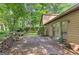 Backyard featuring a patio with stone retaining wall, mature trees and manicured landscaping at 4920 Tremont Ne Dr, Marietta, GA 30066