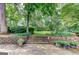 Beautiful backyard with a stone patio, terraced landscaping, lush greenery, and mature trees at 4920 Tremont Ne Dr, Marietta, GA 30066