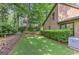 Backyard featuring manicured green grass, mature trees, and well-kept landscaping at 4920 Tremont Ne Dr, Marietta, GA 30066
