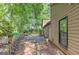 Backyard featuring a patio with stone retaining wall, beautiful mature trees and lush landscaping at 4920 Tremont Ne Dr, Marietta, GA 30066