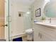 Bright bathroom featuring a walk-in shower, toilet and vanity with white cabinets and a framed round mirror at 4920 Tremont Ne Dr, Marietta, GA 30066