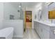 Open bathroom featuring soaking tub, glass enclosed shower and dual sink vanity at 4920 Tremont Ne Dr, Marietta, GA 30066