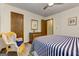 Bedroom with bed, ceiling fan, closet and wicker chair at 4920 Tremont Ne Dr, Marietta, GA 30066