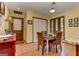 A dining room area with warm wood floors and a view of the kitchen and a door to the outside at 4920 Tremont Ne Dr, Marietta, GA 30066