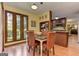 A dining room area featuring 3 large windows, a dining table, and chairs with a view of the kitchen at 4920 Tremont Ne Dr, Marietta, GA 30066