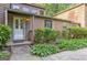 Close-up view of a charming front porch with a white door and well-manicured landscaping at 4920 Tremont Ne Dr, Marietta, GA 30066