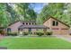 Charming two-story home with a well-manicured lawn, stone accents, and an attached two-car garage at 4920 Tremont Ne Dr, Marietta, GA 30066