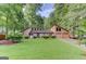 Charming two-story home with a well-manicured lawn, mature trees, and an attached two-car garage at 4920 Tremont Ne Dr, Marietta, GA 30066