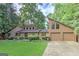 Charming two-story home with a well-manicured lawn, stone accents, and an attached two-car garage at 4920 Tremont Ne Dr, Marietta, GA 30066