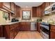 Close-up of the kitchen featuring wood cabinets, granite countertops, and stainless steel appliances at 4920 Tremont Ne Dr, Marietta, GA 30066