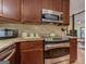 Close-up of the kitchen featuring stainless appliances, granite countertops, and warm wood cabinets at 4920 Tremont Ne Dr, Marietta, GA 30066