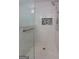 Elegant glass shower featuring gray tile, modern fixtures and built in storage at 4920 Tremont Ne Dr, Marietta, GA 30066