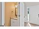 Hallway bathroom featuring a granite countertop, sink, and white vanity at 2821 Amhurst Nw Way, Kennesaw, GA 30144