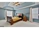 Bedroom featuring a tray ceiling, a ceiling fan, and natural lighting at 2821 Amhurst Nw Way, Kennesaw, GA 30144