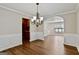 Open dining room featuring wood floors, chair rail, a chandelier, and archway at 2821 Amhurst Nw Way, Kennesaw, GA 30144