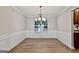 Bright dining room featuring wood floors, a chandelier, chair rail, and a large window at 2821 Amhurst Nw Way, Kennesaw, GA 30144