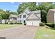 Well-maintained home with a long driveway, a two-car garage, and manicured landscaping at 2821 Amhurst Nw Way, Kennesaw, GA 30144