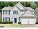 Charming two-story home with a well-manicured lawn, blue shutters, and an attached two-car garage at 2821 Amhurst Nw Way, Kennesaw, GA 30144