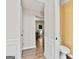 Hallway featuring wood flooring, chair rail, and archway with a view of the kitchen at 2821 Amhurst Nw Way, Kennesaw, GA 30144