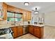 Well-lit kitchen featuring wood cabinets, granite countertops, stainless steel appliances, and wood flooring at 2821 Amhurst Nw Way, Kennesaw, GA 30144