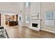 Spacious living room with open access to the kitchen and a cozy fireplace at 2821 Amhurst Nw Way, Kennesaw, GA 30144