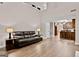 Open-concept living room with a fireplace, tall ceilings, and hardwood floors flowing into the kitchen at 2821 Amhurst Nw Way, Kennesaw, GA 30144