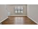 Spacious living room featuring wood flooring, a window, and base trim at 2821 Amhurst Nw Way, Kennesaw, GA 30144
